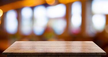 Empty wooden table top with lights bokeh on blur restaurant background photo