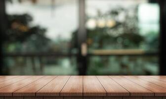 Empty wooden table top with lights bokeh on blur restaurant background photo