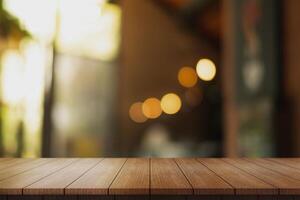 Empty wooden table top with lights bokeh on blur restaurant background. photo