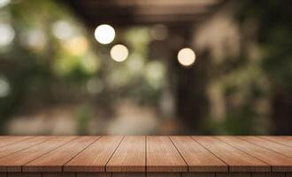 Empty wooden table top with lights bokeh on blur restaurant background. photo