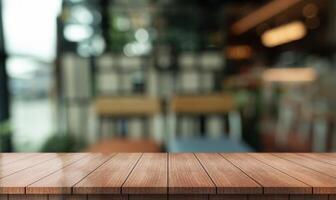 Empty wooden table top with lights bokeh on blur restaurant background photo