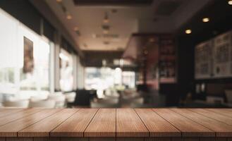 Empty wooden table top with lights bokeh on blur restaurant background. photo