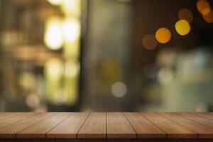 Empty wooden table top with lights bokeh on blur restaurant background. photo