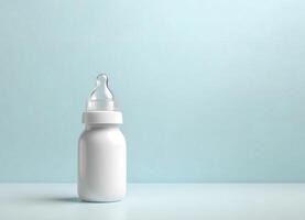 white baby bottle pacifier on a minimalistic pink background photo