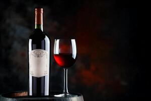 Glass of red wine and bottle of wine in old wooden barrel photo