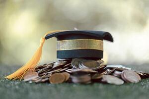 Graduation from college with university degree in finance marked successful culmination of education, envisioning value of each coin invested. coin, college, education, graduation, hat, school. photo