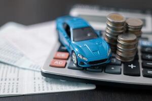 Business concept involved using finance calculator to determine premium for vehicle policy, ensuring clear financial contract for car. Investing in auto insurance can save money on transport costs. photo