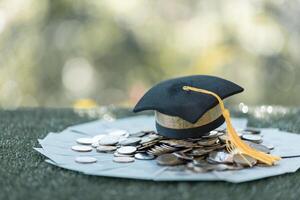 Graduation from college with university degree in finance marked successful culmination of education, envisioning value of each coin invested. coin, college, education, graduation, hat, school. photo