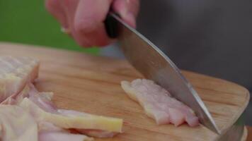 a cook cuts a fresh sturgeon straw into slices for lunch, food preparation video