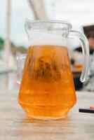 Jar of beer on wood table photo