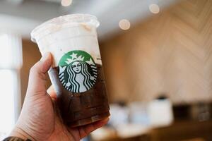 Bangkok, Thailand - May 10, 2024 Close up a cup of Starbuck coffee, cold foam iced espresso. photo