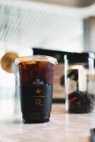 Samut Prakan, Thailand - May 10, 2024 Starbucks Reserve iced black coffee on table photo