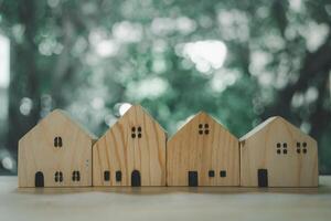 A different wood house model against nature background photo