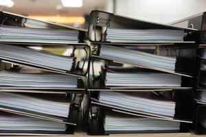 Files stacked on filing cabinet. Overflowing with documentation photo