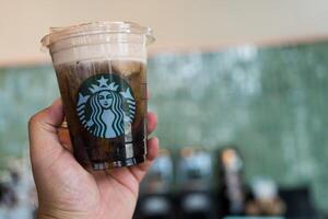 Samut Prakan, Thailand - May 21, 2024 Close up iced cold brew Americano topped with milk foam. STARBUCKS photo