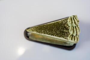 Green tea crepe cake with layers of thin crepes separated with cream. photo