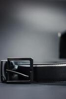 Men belts made of genuine black with a metal buckle. photo