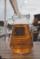 Full pitcher of beer. Drinking alcohol at open air photo