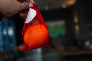 Oranges fruit in red bag for give to other during Chinese New Year festival. Believed to bring good luck and happiness. photo