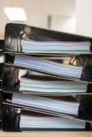 Files stacked on filing cabinet. Overflowing with documentation photo