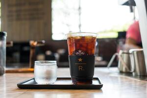 Samut Prakan, Thailand - May 1, 2024 Iced black coffee at at Starbucks Reserve bar served with cool water. photo