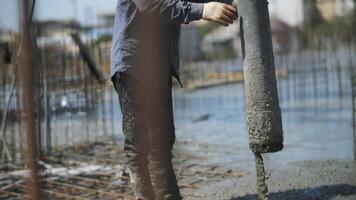 A builder pours concrete into a monolithic slab with reinforcement video