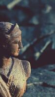 ancient statue of woman on rocky stones video