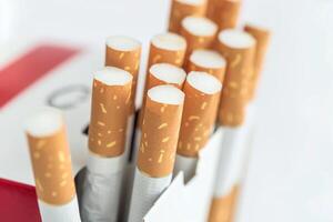 Cigarettes inside the pack. Concept of smoking and harm to health. Close-up photo