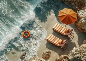 Two Lounge Chairs and an Umbrella on a Beach photo