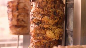 Close-up slow motion footage of big piece of roasted meat cooked for Turkish shawarma, grilled Greek gyros, souvlaki dishes. Selective focus video