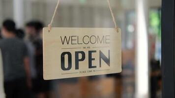 Young Asia girl wear face mask turning a sign from open to closed sign on glass door cafe after coronavirus lockdown quarantine. Owner small business, food and drink, business financial crisis concept video