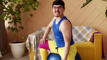 Indoors portrait of man in bright sport clothes exercising with small dumbbells at home,slow motion. Funny Sport activity video