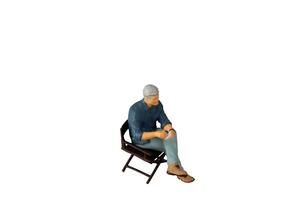 A businessman seated on a chair and sipping hot coffee isolated on white background with clipping path photo