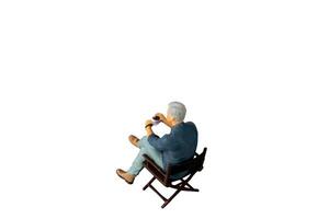 A businessman seated on a chair and sipping hot coffee isolated on white background with clipping path photo