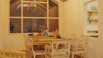 Cozy dining room with wooden table and chandelier video