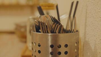 Close-up of metal utensil holder with forks and spoons video