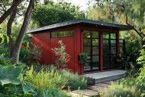 A contemporary white backyard shed with a flat roof, large doors, and surrounded by greenery photo