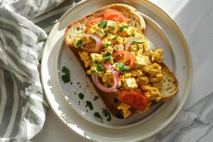 Scrambled egg served with bread photo