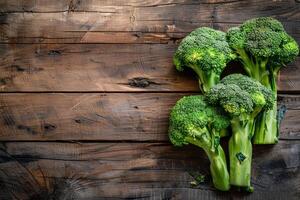 Fresh broccoli on wooden background photo