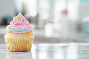 Single cupcake with colorful icing on table photo