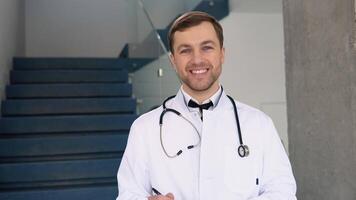 Male doctor standing in clinic in a hallway. Perfect medical service in hospital. Medicine and healthcare concept video