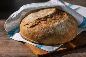 homemade whole grain bread in the kitchen on a wooden table 1 photo