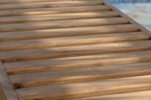 wooden sun loungers in the sun's rays as a background 1 photo