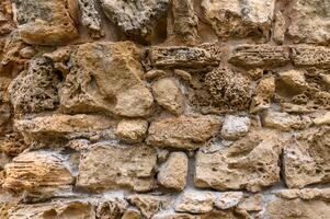 antecedentes de antiguo ladrillo pared. textura de antiguo anfiteatro Roca foto