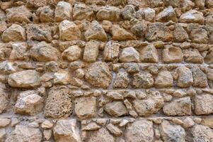 textura de un antiguo ladrillo pared hecho de arenisca. arqueológico excavaciones foto