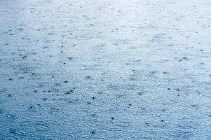 River in the rain. Water surface during a downpour photo