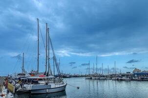 yachts and ships in the port in Limassol Cyprus in spring cloudy photo