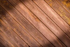 Wooden wall made of diagonal boards with light brown stripes. Background.1 photo