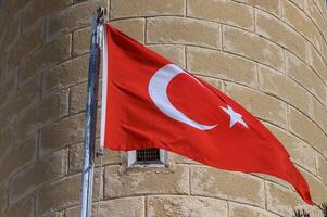 Turkish flag on the background of a brick wall of the mosque 1 photo