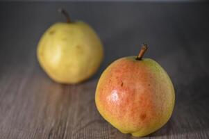 two juicy pears on a wooden table, studio shooting 3 photo